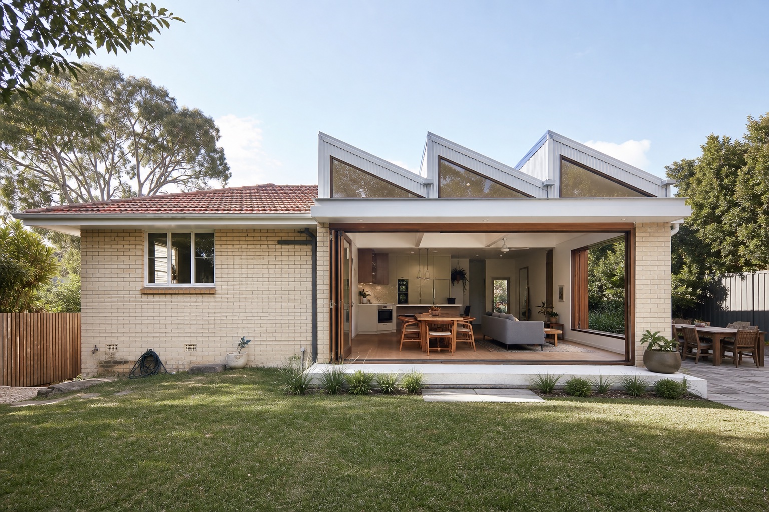 Camp Hill cream brick home with a sawtooth roof extension